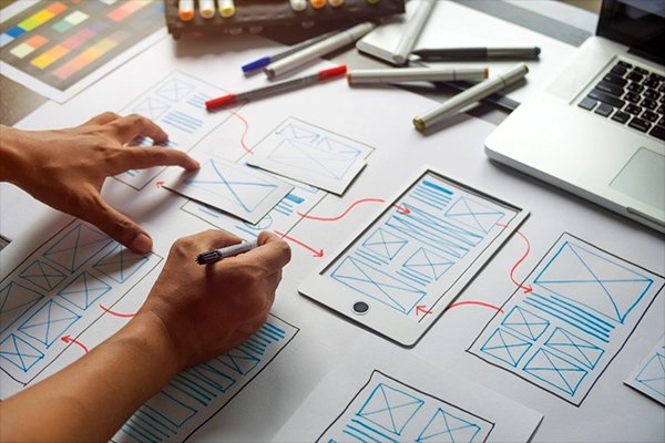 Hand sketching app wireframes on paper